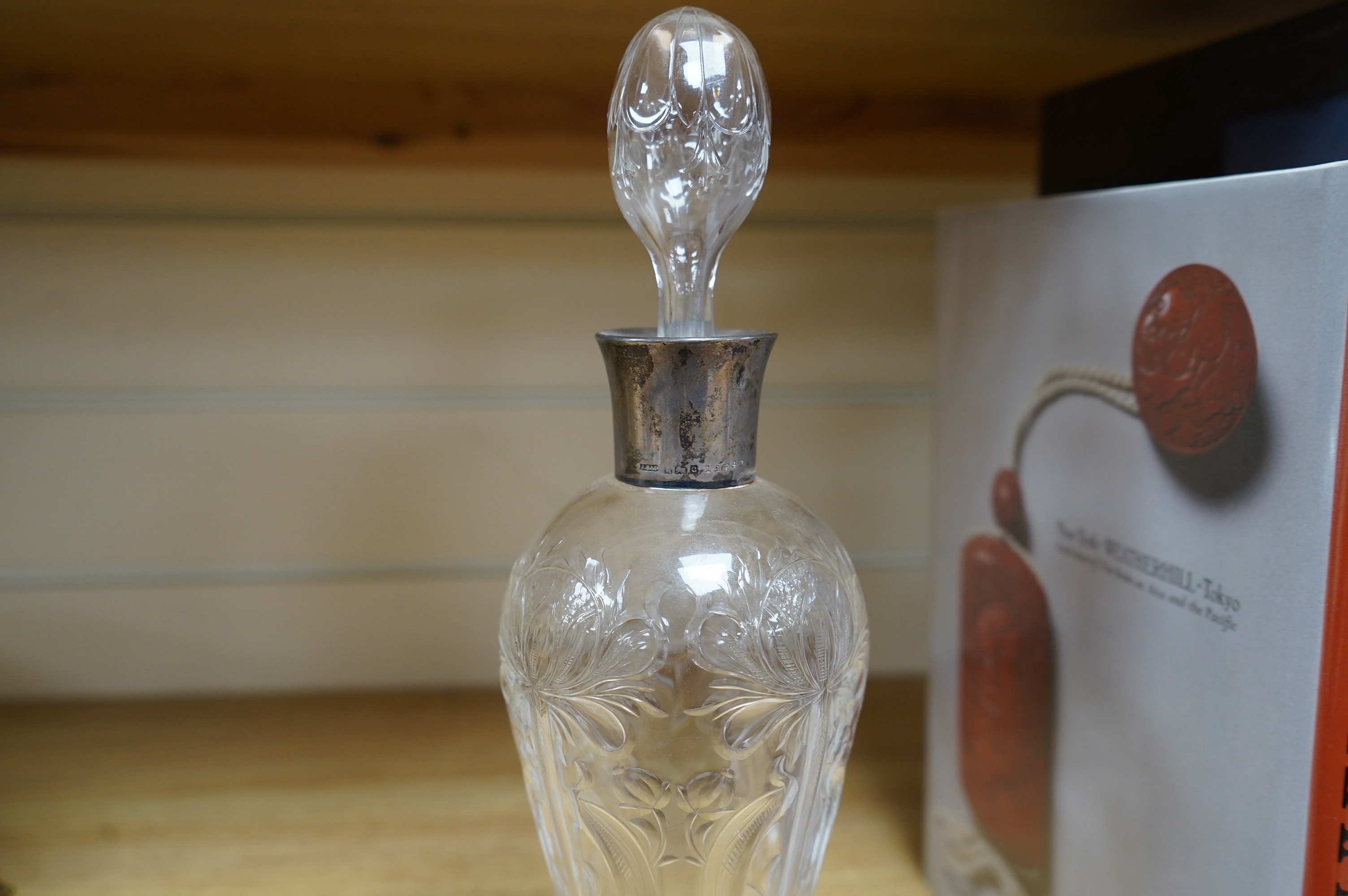 An Edwardian Art Nouveau silver mounted Stourbridge glass decanter, engraved with stylised flowers, John Grinsell & Sons, Birmingham, 1902, 30.5cm high. Condition - good